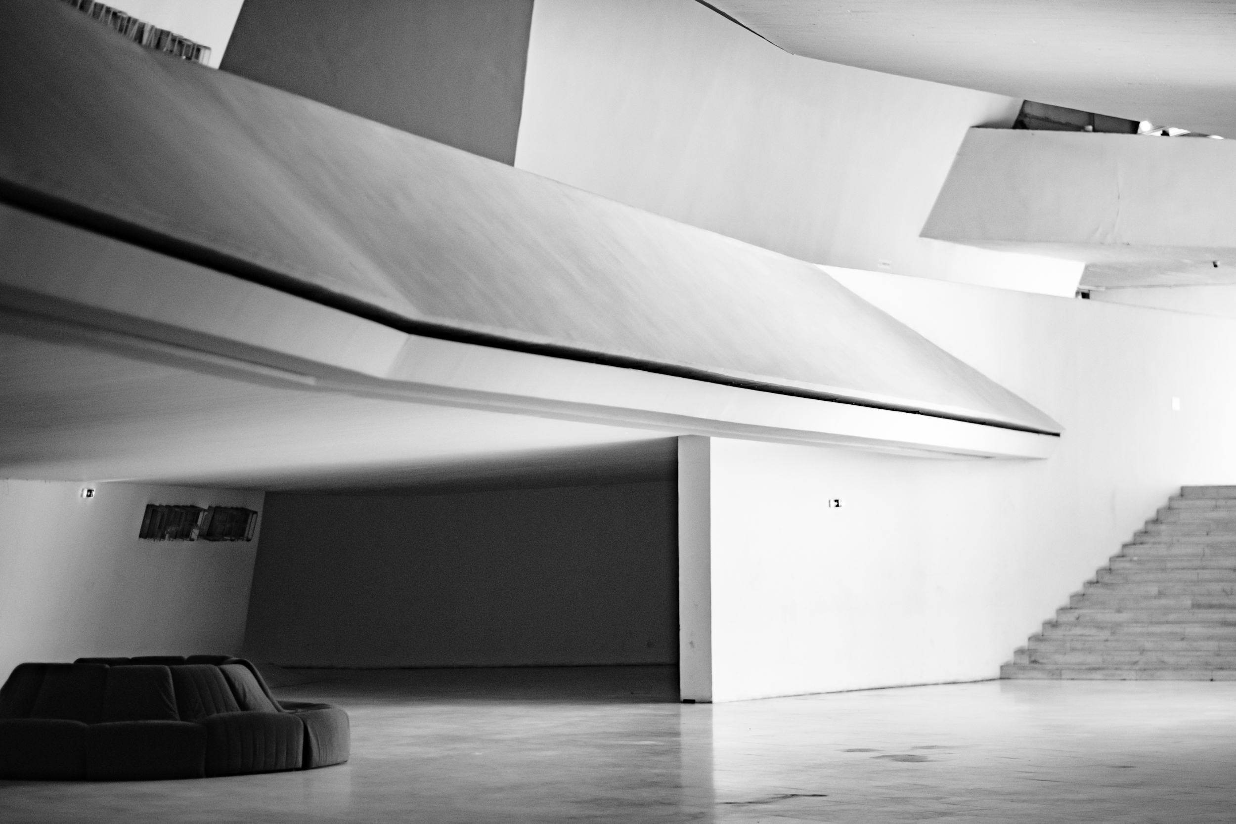 An empty modern foyer with strong horizontal and diagonal architectural lines.